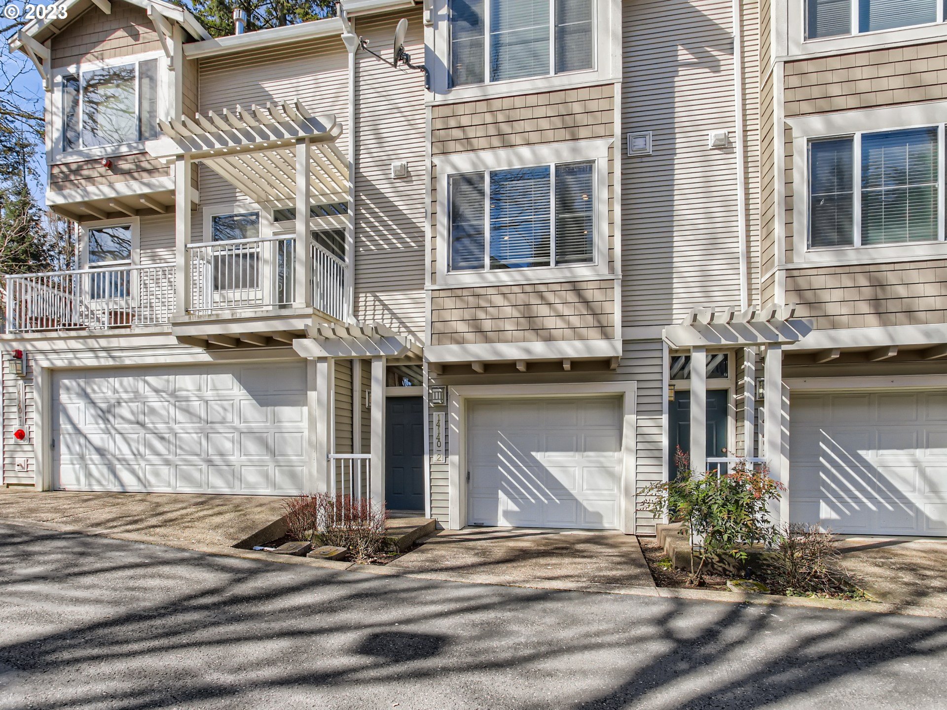 14140 Southwest Barrows Road, Unit 2 Portland, OR 97223 - Photo 2 of 30 a front view of a house with a garden
