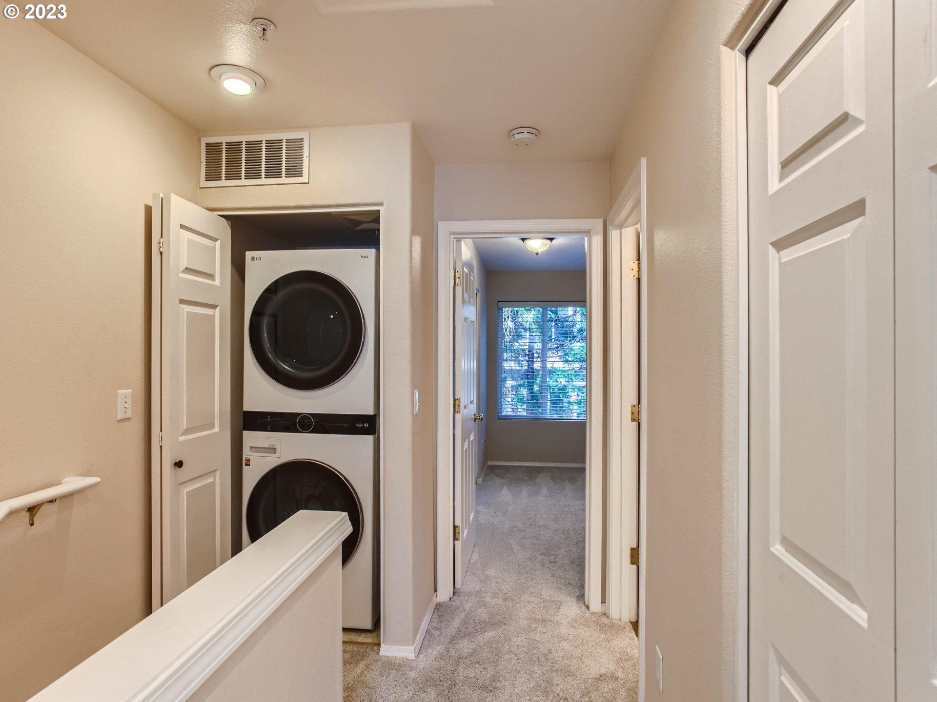 14140 Southwest Barrows Road, Unit 2 Portland, OR 97223 - Photo 21 of 30 a view of a hallway with washer and dryer