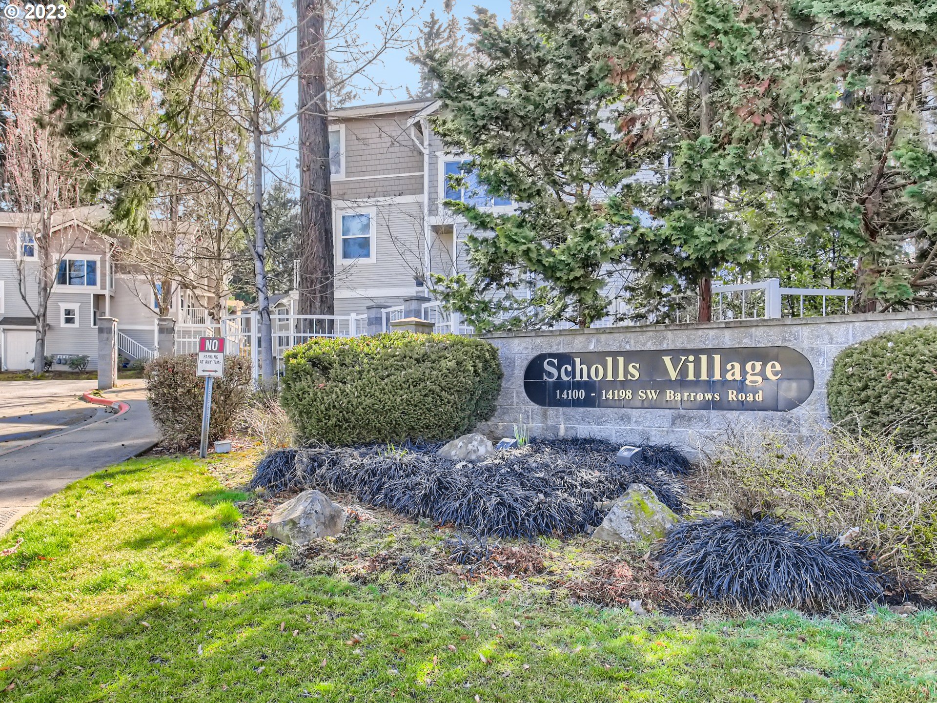 14140 Southwest Barrows Road, Unit 2 Portland, OR 97223 - Photo 27 of 30 a view of a street sign under a large tree