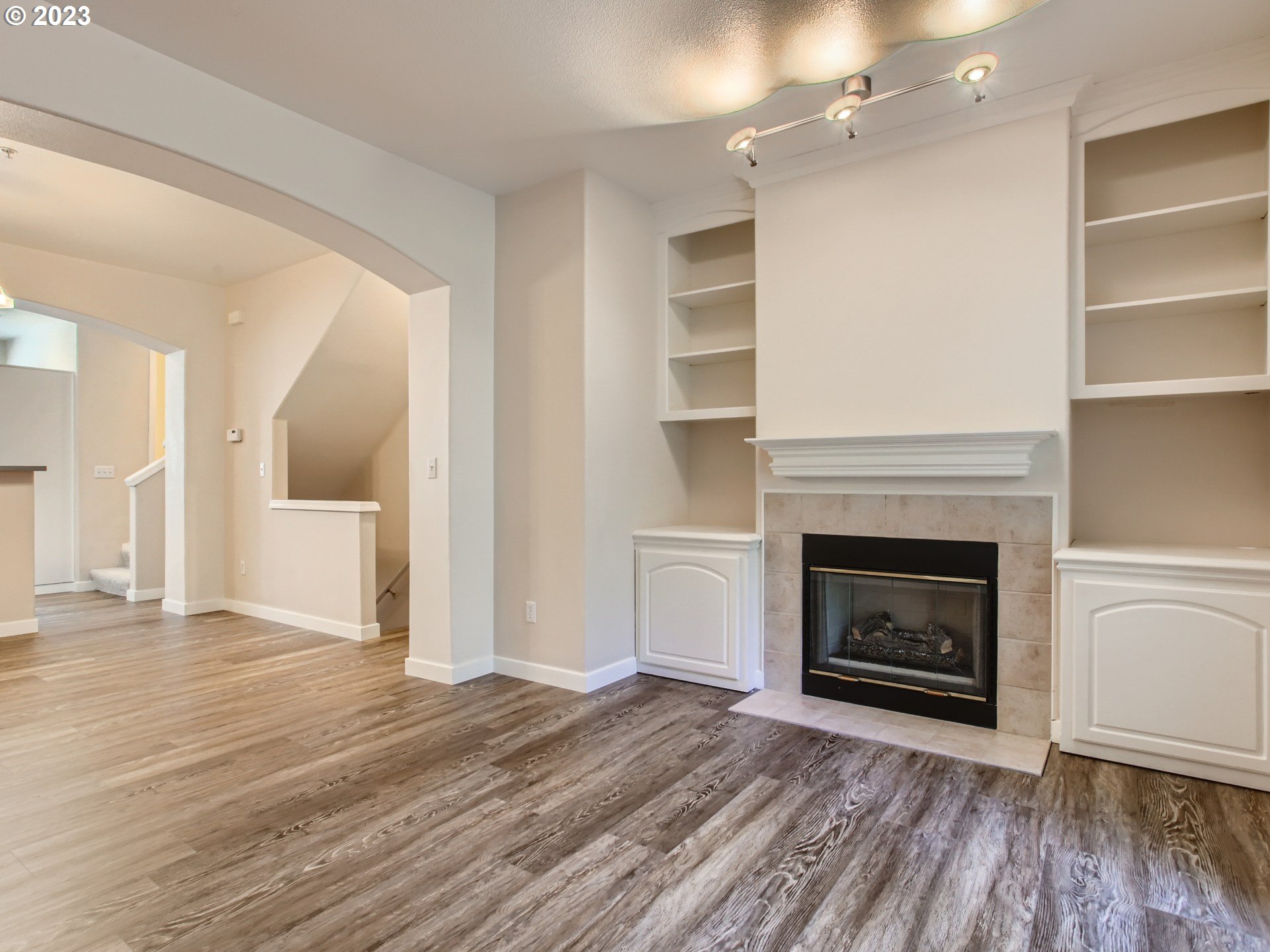 14140 Southwest Barrows Road, Unit 2 Portland, OR 97223 - Photo 7 of 30 a view of a livingroom with a fireplace wooden floor and fire place