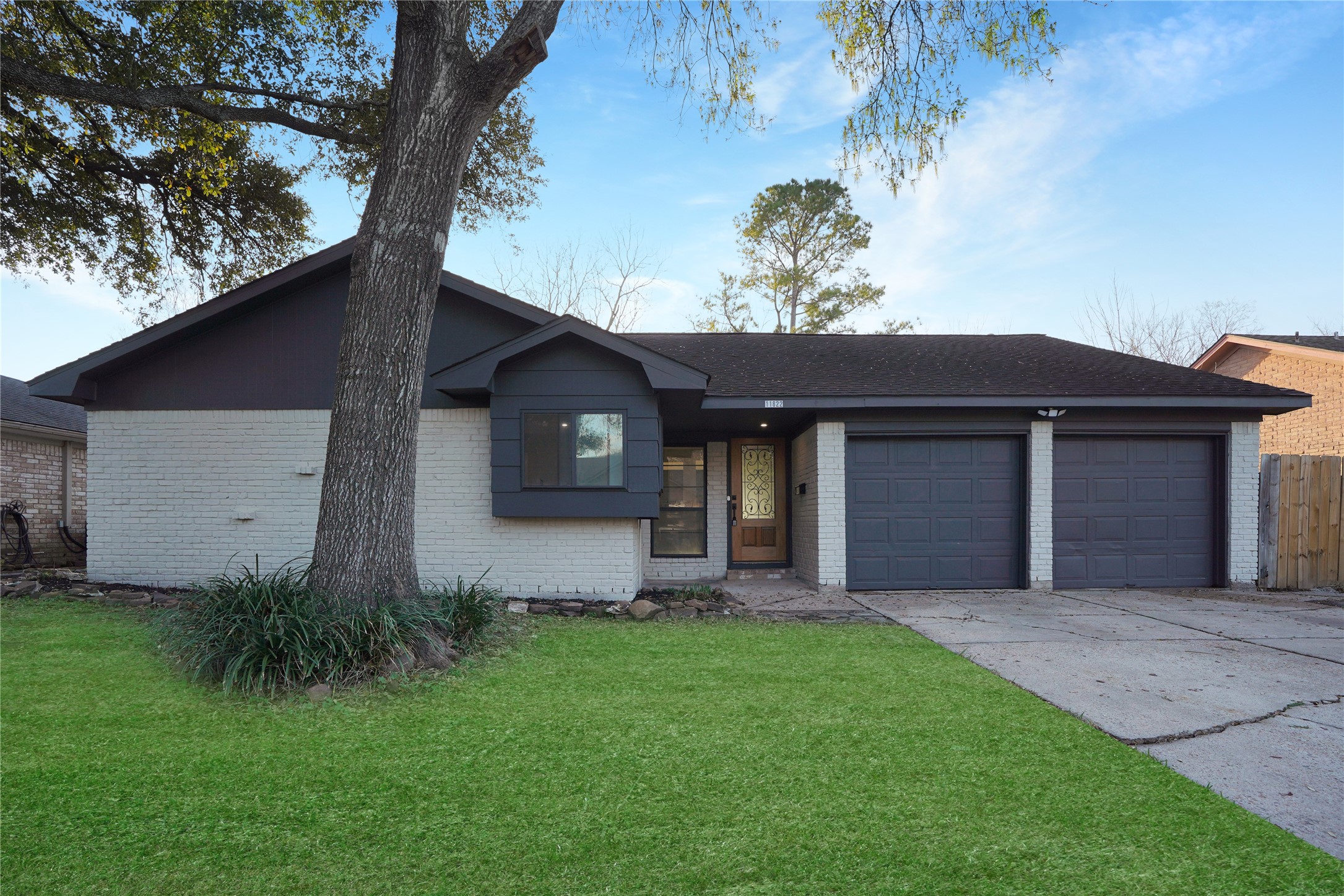 11822 South Perry Avenue Houston, TX 77071 - Photo 1 of 23 a front view of a house with a garden and yard