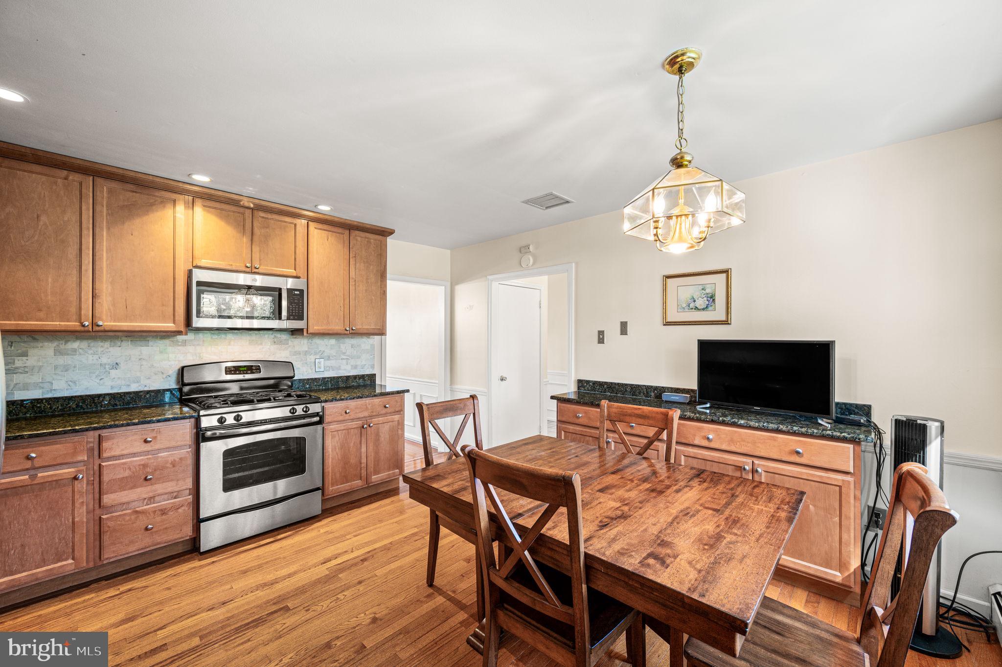 1231 Gail Road West Chester, PA 19380 - Photo 12 of 49 a view of a dining room with furniture a chandelier and wooden floor