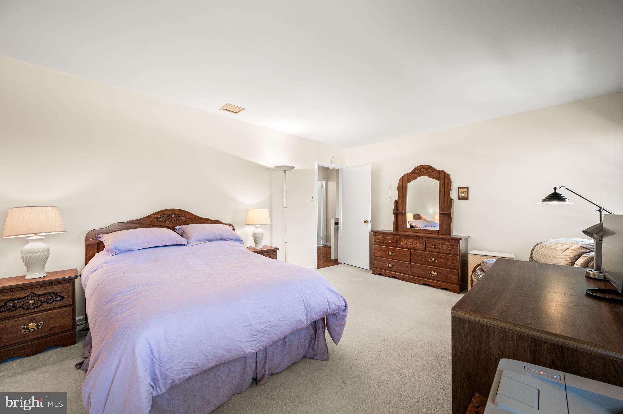 1231 Gail Road West Chester, PA 19380 - Photo 26 of 49 a bedroom with a bed and a dresser with mirror