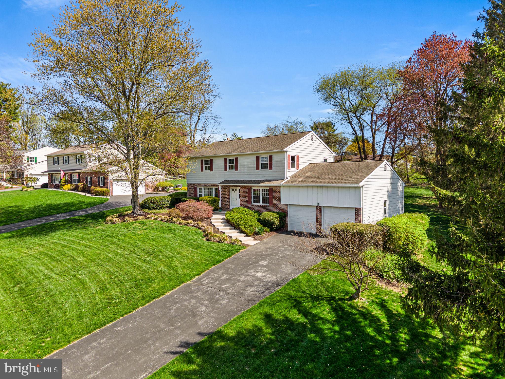 1231 Gail Road West Chester, PA 19380 - Photo 3 of 49 a front view of a house with a garden and trees