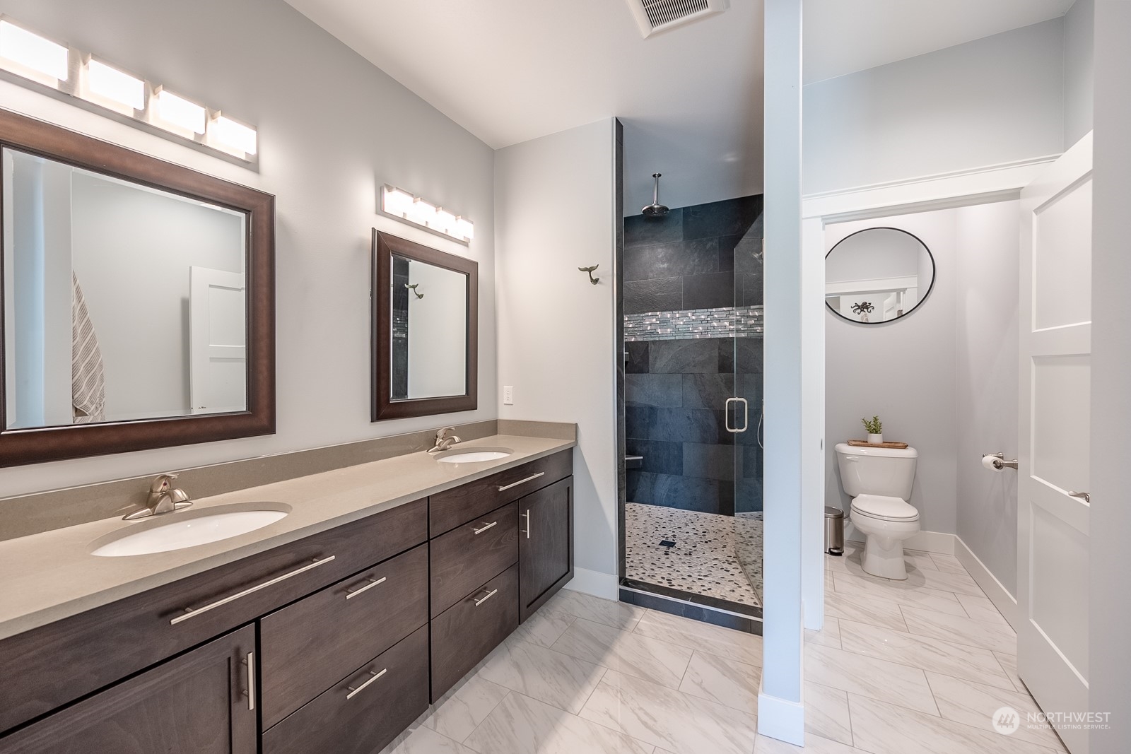 949 Spring Mountain Drive Wenatchee, WA 98801 - Photo 14 of 33 a bathroom with a sink a toilet a large mirror and shower