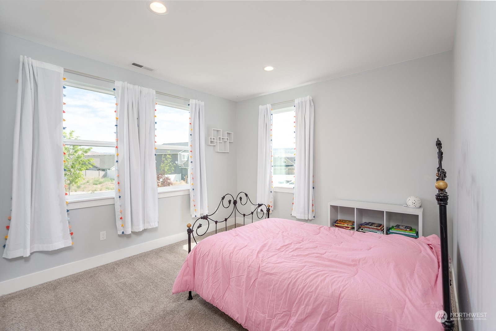 949 Spring Mountain Drive Wenatchee, WA 98801 - Photo 17 of 33 a bed sitting in a spacious bedroom next to a window
