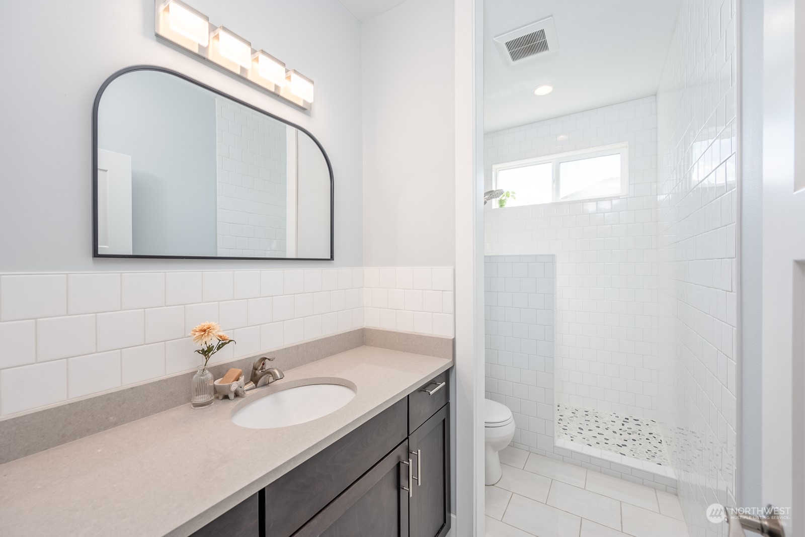 949 Spring Mountain Drive Wenatchee, WA 98801 - Photo 19 of 33 a bathroom with a granite countertop sink a toilet and a mirror
