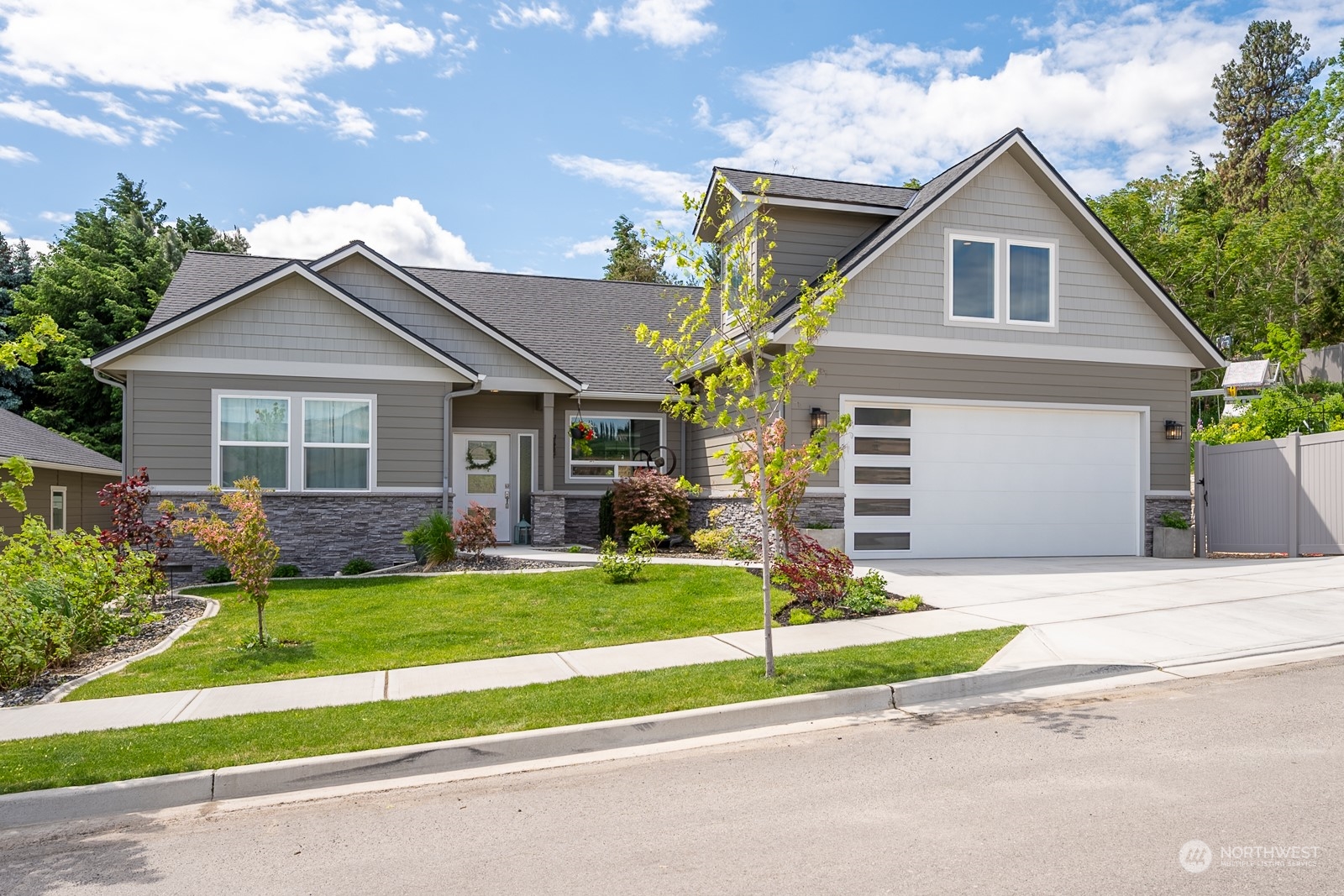949 Spring Mountain Drive Wenatchee, WA 98801 - Photo 32 of 33 a front view of a house with a yard and garage