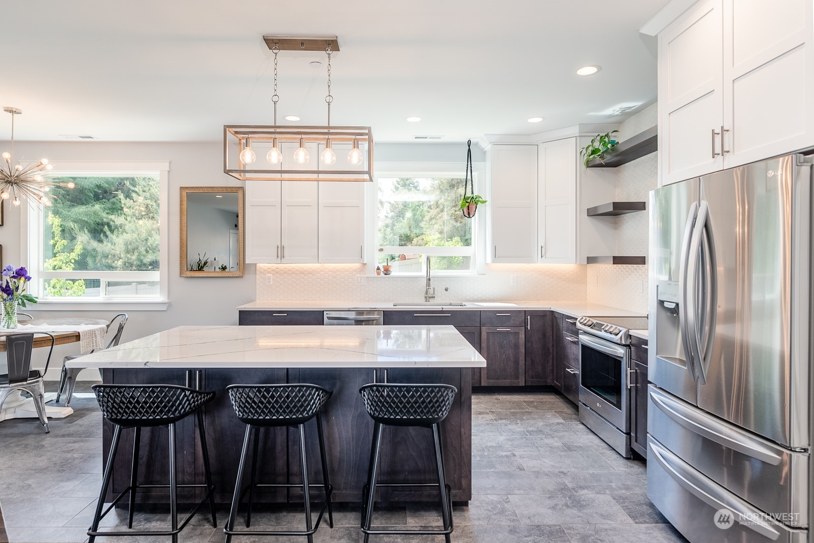 949 Spring Mountain Drive Wenatchee, WA 98801 - Photo 9 of 33 a kitchen with stainless steel appliances granite countertop a stove a refrigerator a sink a dining table and chairs with wooden floor