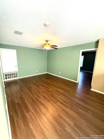 a view of a room with wooden floor