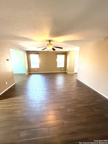 a view of a room with wooden floor