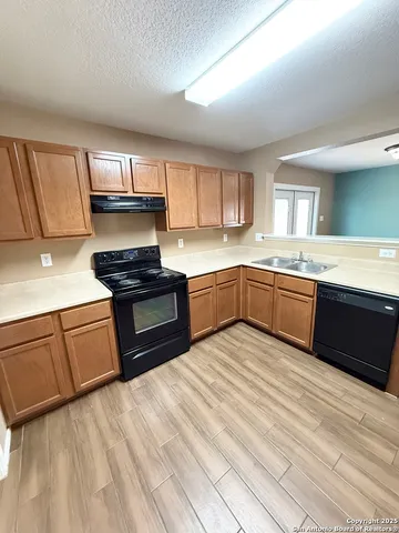 a kitchen with stainless steel appliances granite countertop a sink stove and cabinets