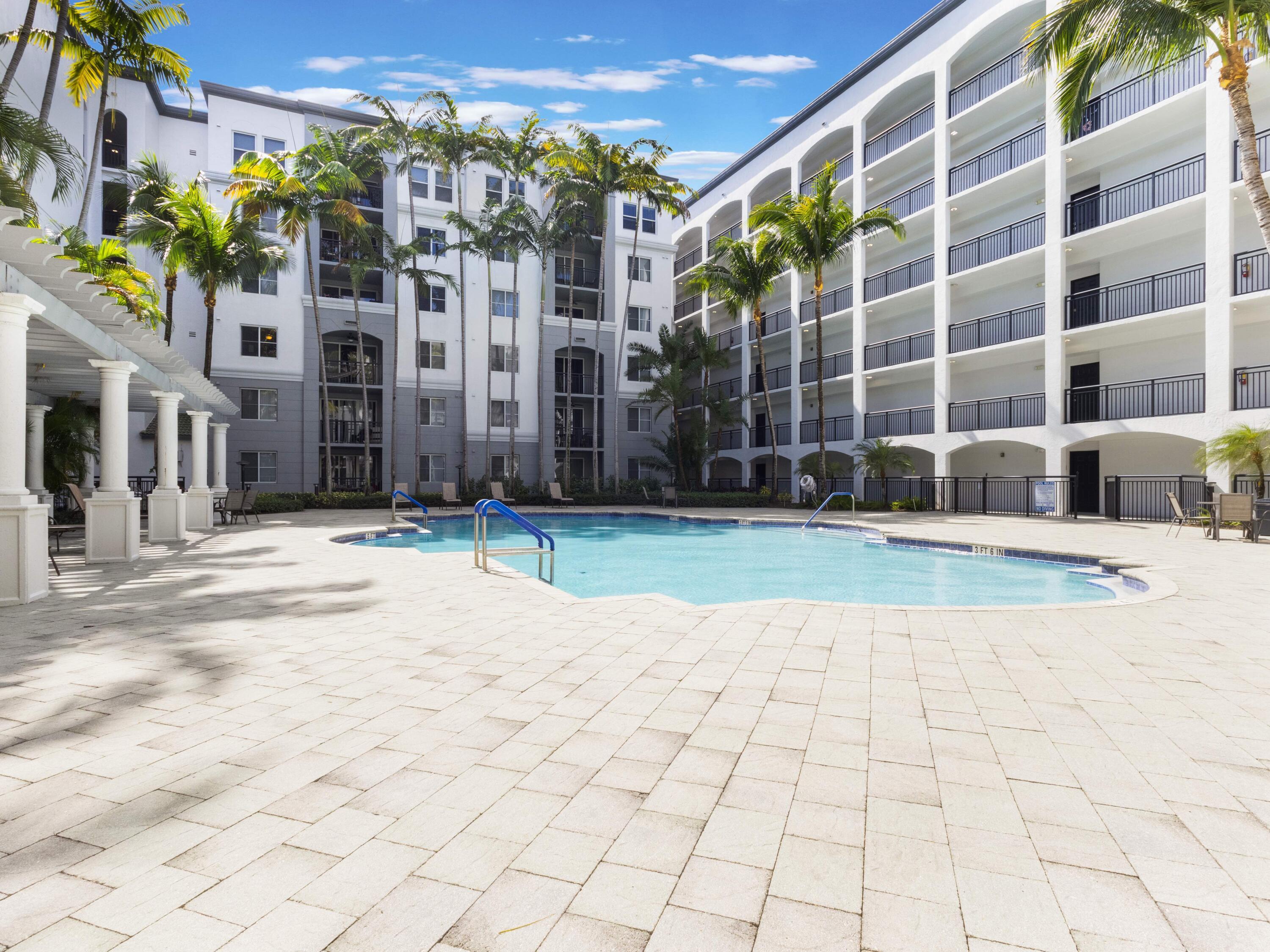 1690 Renaissance Commons Boulevard, Unit 1412 Boynton Beach, FL 33426 - Photo 29 of 49 a view of a building with a yard