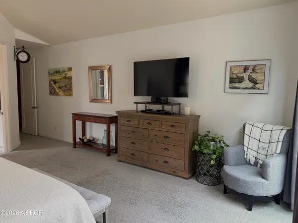 a spacious bedroom with a bed and a large window