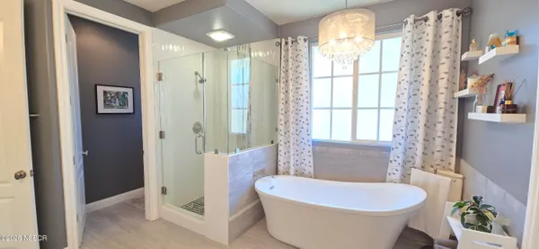 a spacious en suite bathroom with double sink and a large mirror