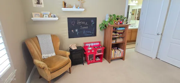 a view of a workspace with a window and a chair