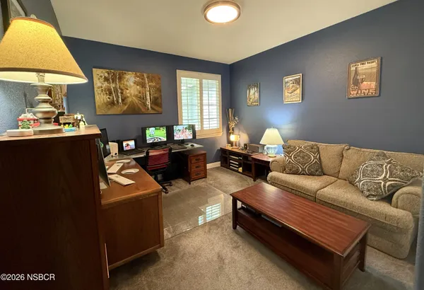 a living room with furniture and flowers