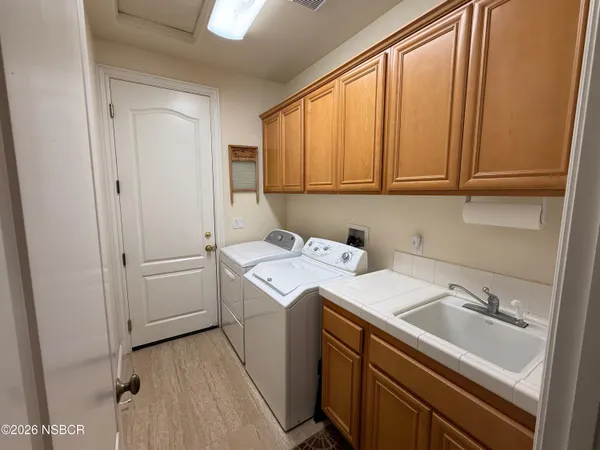 a living room with furniture a bookshelf and a window