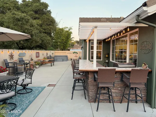 a view of a chairs and table in patio