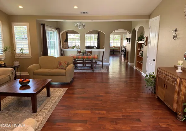 a living room with furniture and wooden floor