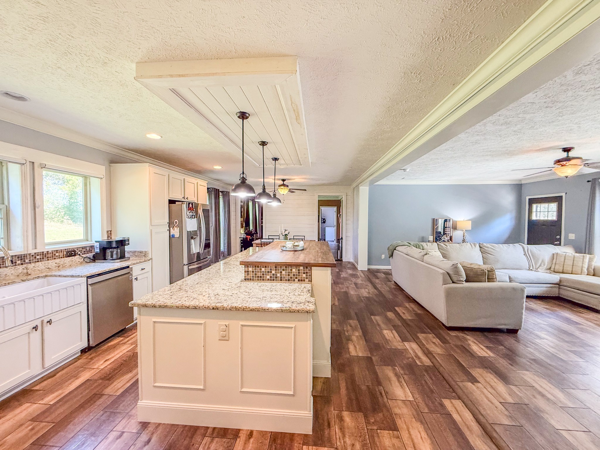 137 Hawkins Road Westmoreland, TN 37186 - Photo 27 of 71 a living room with kitchen island granite countertop furniture and a kitchen view