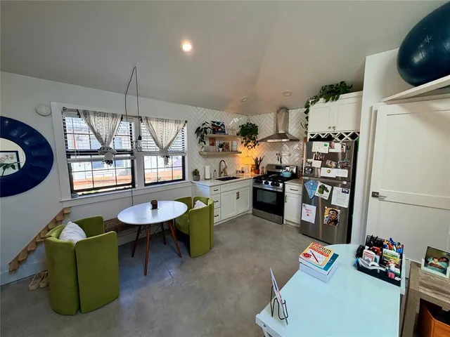 a kitchen with a refrigerator and a stove