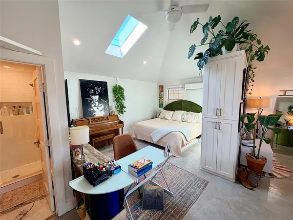 a bedroom with furniture and a potted plant