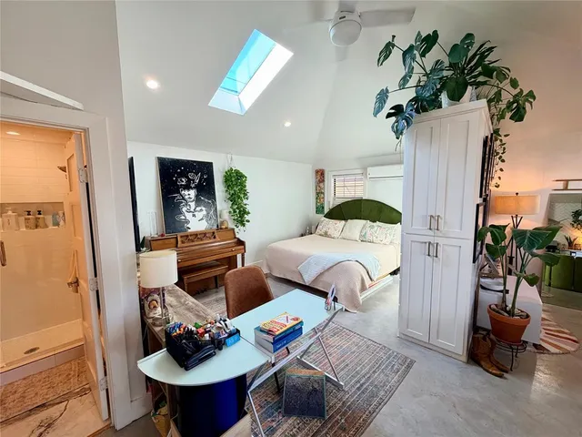 a bedroom with furniture and a potted plant