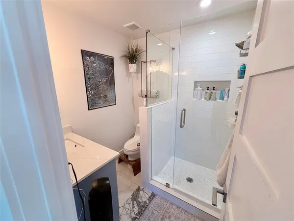 a bathroom with a shower and a toilet
