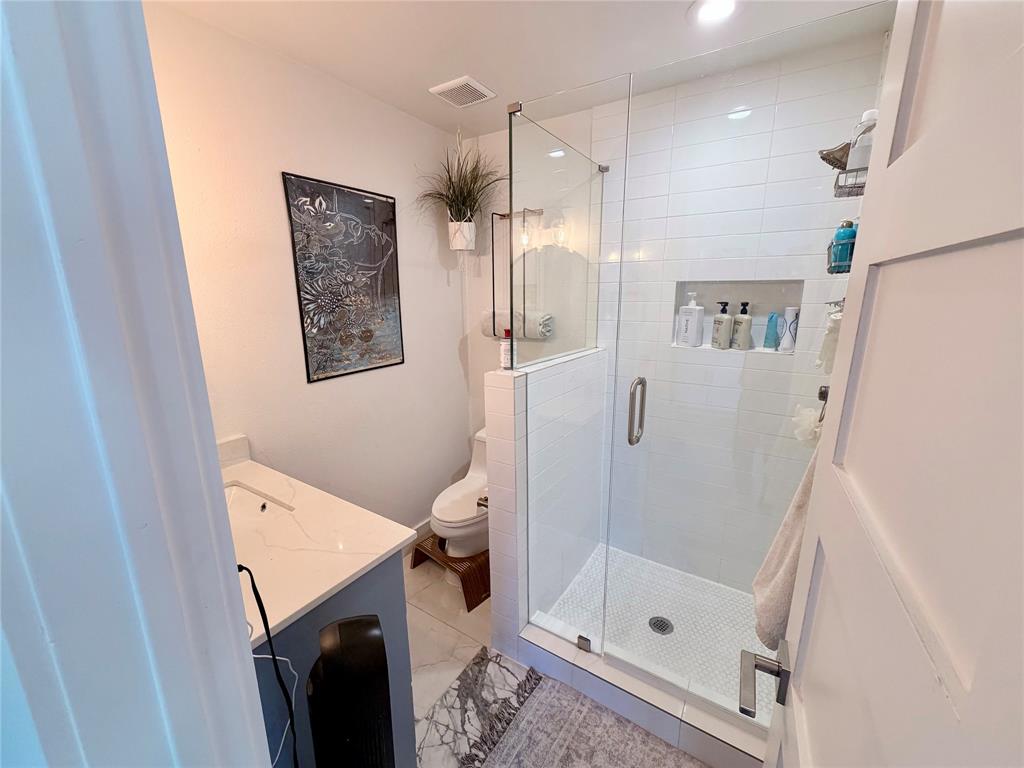 315 Easton Road, Unit B Dallas, TX 75218 - Photo 8 of 10 a bathroom with a shower and a toilet