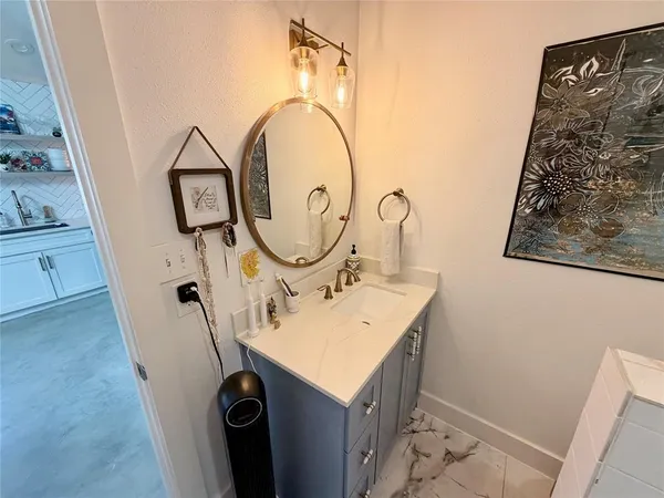 a bathroom with a sink and a mirror
