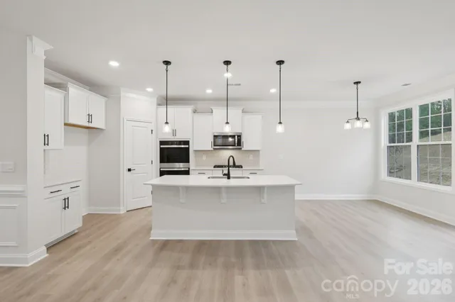 a view of kitchen with sink microwave and refrigerator