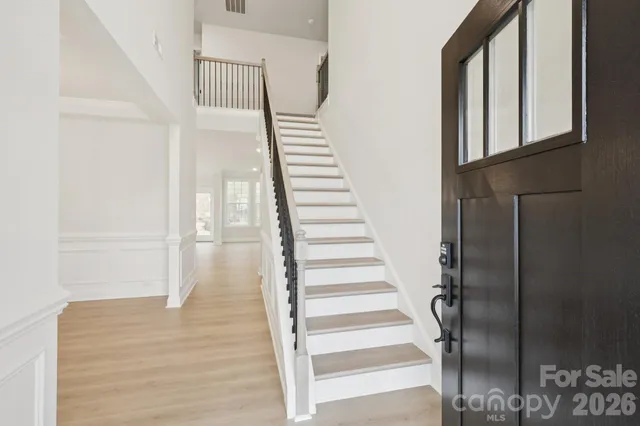 a view of entryway and hall with wooden floor