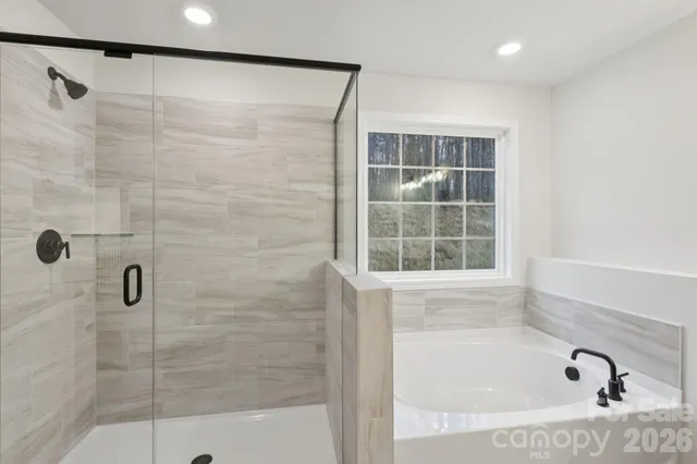 a bathroom with a bathtub and shower