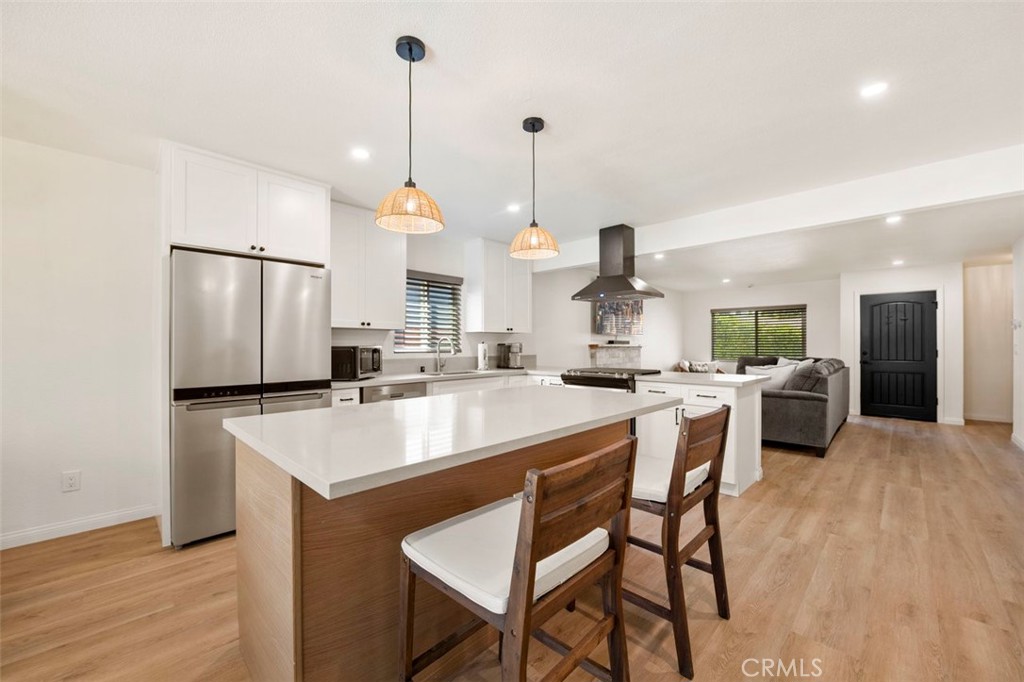 332 Cadillac Circle Oceanside, CA 92054 - Photo 13 of 31 a kitchen with stainless steel appliances kitchen island granite countertop a sink a stove and chairs