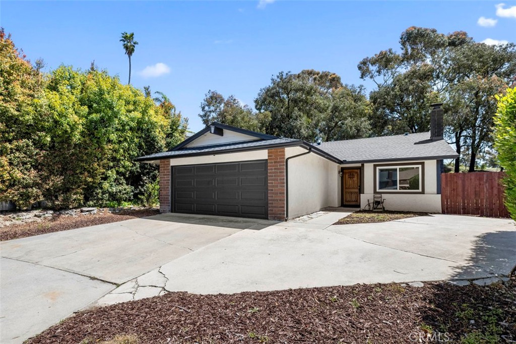 332 Cadillac Circle Oceanside, CA 92054 - Photo 2 of 31 a front view of a house with a garage
