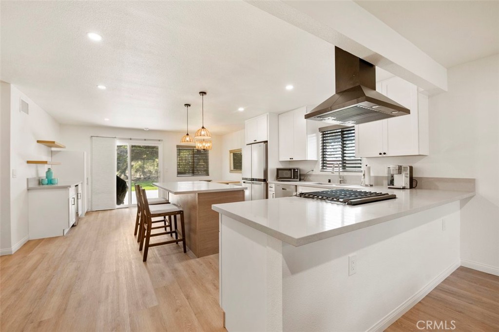 332 Cadillac Circle Oceanside, CA 92054 - Photo 8 of 31 a kitchen with stainless steel appliances a stove a sink a dining table and chairs