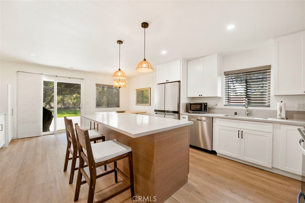 332 Cadillac Circle Oceanside, CA 92054 - Photo 9 of 31 a kitchen with white cabinets and white appliances