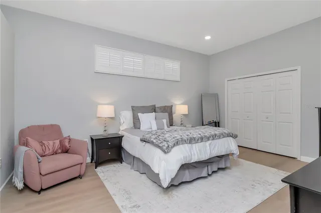 a bedroom with a bed couch and a dresser