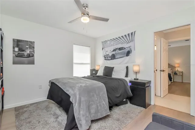 a bedroom with a bed and a painting on the wall