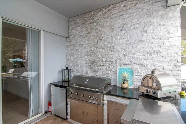 a kitchen with granite countertop a stove top oven cabinetry a sink and a counter top space