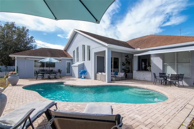 a view of a house with backyard porch and sitting area