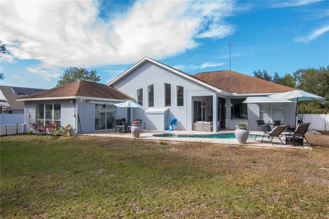 a front view of a house with sitting area and garden