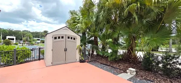 a front view of a house with a yard garage and outdoor seating