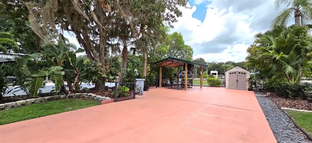 568 Waterway Drive River Ranch, FL 33867 - Photo 14 of 21 a front view of a house with a yard garage and outdoor seating