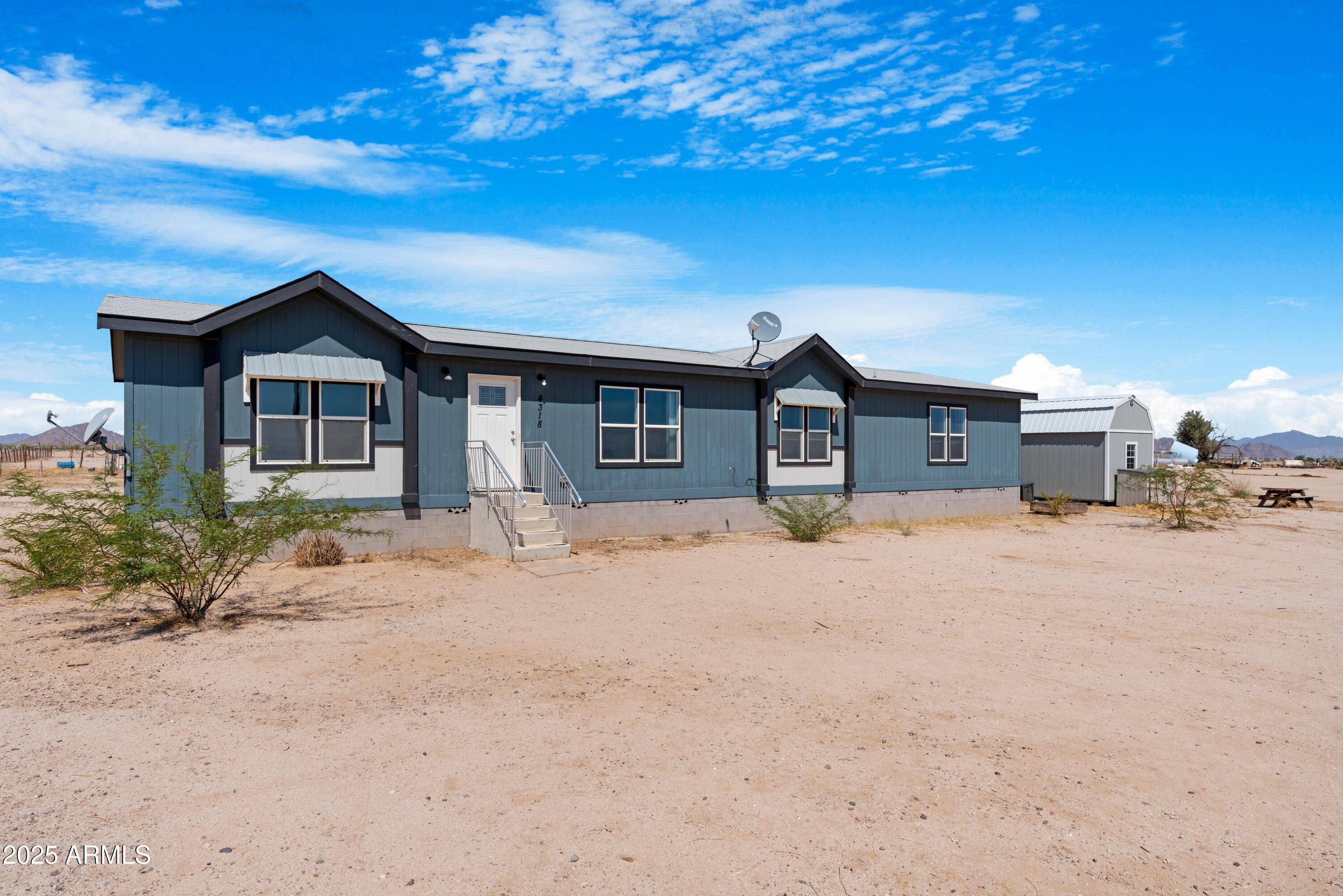 4318 North White Road Maricopa, AZ 85139 - Photo 2 of 21 a front view of a house with a yard