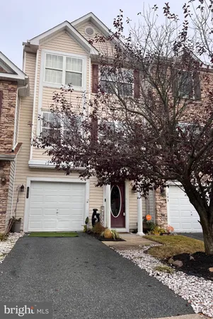 a view of a house with a yard and garage