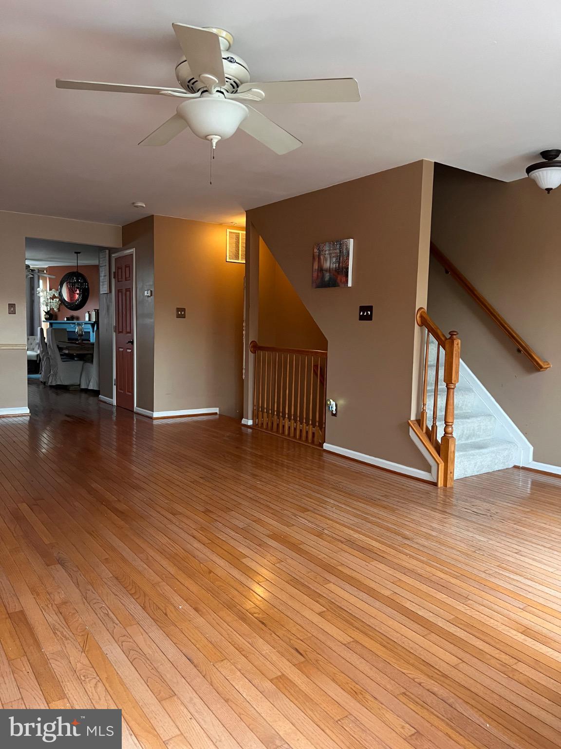 103 Canvasback Way Cambridge, MD 21613 - Photo 13 of 39 a view of a livingroom with wooden floor and a ceiling fan