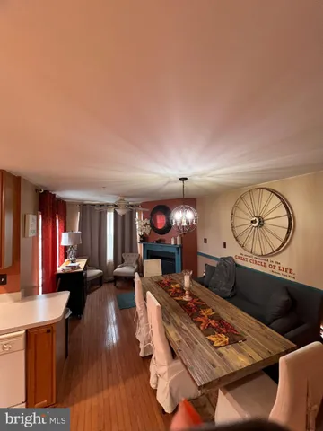 a living room with furniture a rug a fireplace and a window