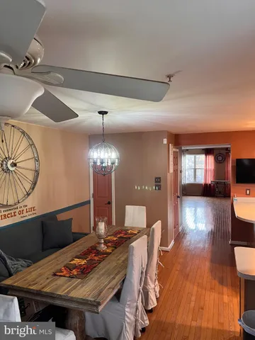 a kitchen with stainless steel appliances a refrigerator a sink a stove a microwave and wooden floor